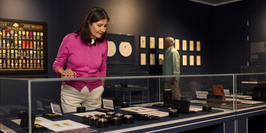 Honours Exhibition with woman looking at the display case