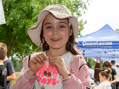 Child holding a coin at the Kids Coin Trade