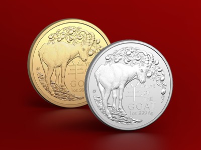 Gold and silver Lunar Year of the Goat investment coins against a red background.